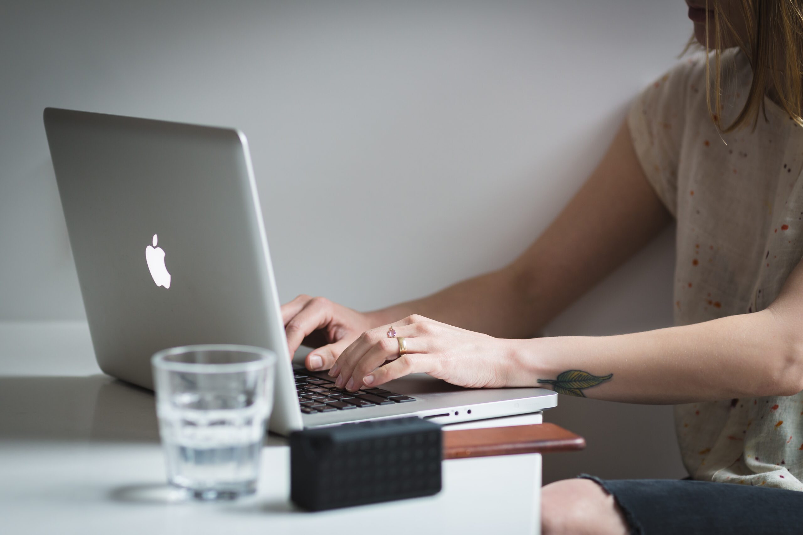 woman sitting at a desk working on a laptop